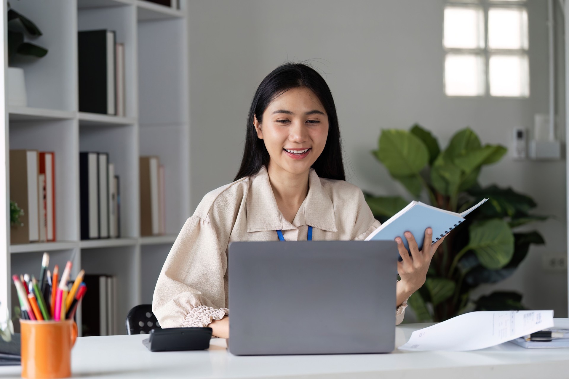 Professional Female Accountant Analyzing Financial Management Documents in Modern Office Setting