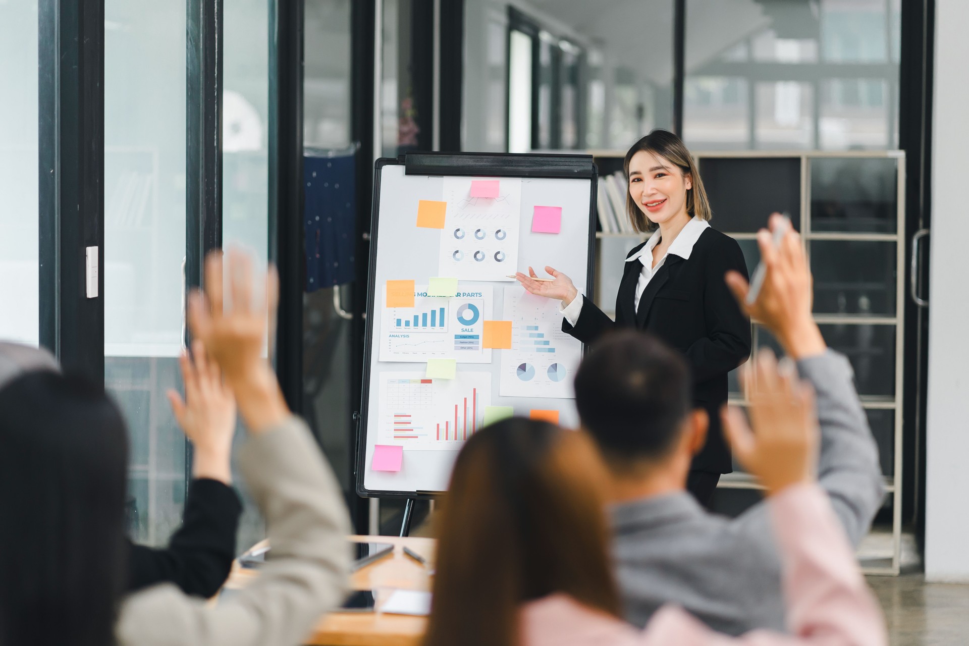 Businesswoman Leading Presentation with Team Participation.